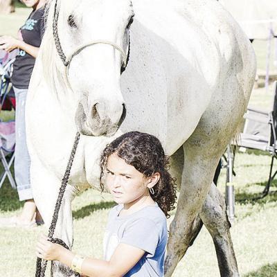 Swayde Grogan leads her horse Iceman into the Clinton Round-Up Club Arena prior to the start of the rodeo. CDN | Sam Goodwyn
