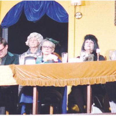 Dinner is served before the carnage begins in the Southwest Playhouse’s production of “Clue.” From left are Colonel Mustard (John Williams), Miss Scarlet (Gina Jones), Yvette (Gini Smith), Mr. Green (Wesley Javorsky), Cook (Karolyn Koester), Mrs. Pe