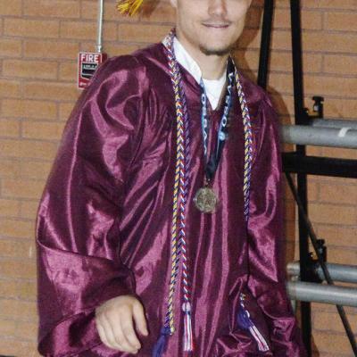 Landon Wilson heads toward center court for his graduation ceremony at the Tornado Dome. CDN | Christian Jacobsen