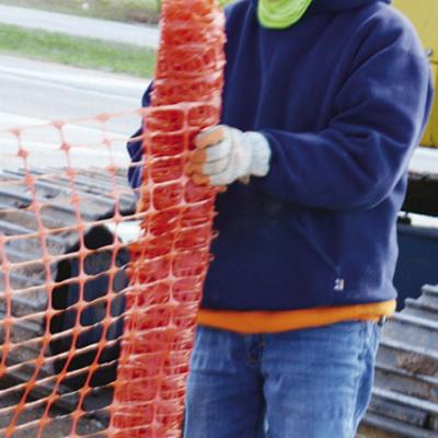 Martin Saucedo removes the fencing around the construction site at Gary Boulevard near Interstate 40. CDN | Michael Maresh