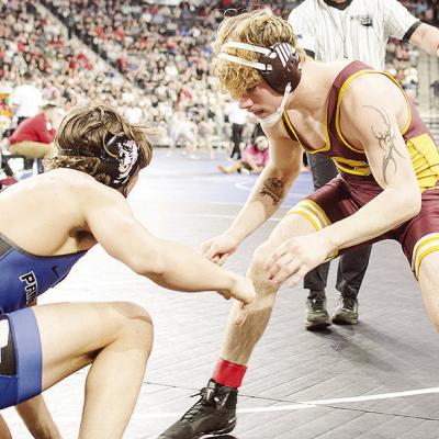 Clinton’s Landon Wilson, right, eyes an opening against his opponent from Harrah in Class 4A 165-pound weight class championship match Saturday at OG&amp;E Coliseum in Oklahoma City. CDN | Sam Goodwyn