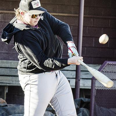 Clinton’s Dylan Hoffman hits the ball hard during practice at the baseball field. CDN | Sam Goodwyn