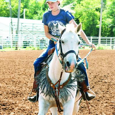 Brandilyn Chenoweth rides her horse Kitty across the finish line after circling the barrel in the middle of the arena and returning for the Clinton Round-Up Club’s Fall Play Days’ Turn and Burn Event for ages 9-13. CDN | Caleb Blanchard Coming through