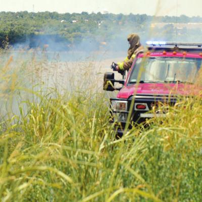 Fire department battles grass fire