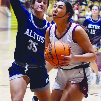 The Lady Reds’ Ali Rodelo braces for impact before scoring an early bucket against Altus. CDN | Emily Stephens CHS battles Altus in overtime thrillers