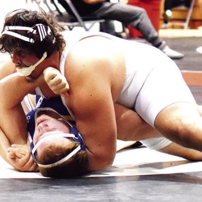 A loose chinstrap on his headgear doesn’t derail Clinton’s Layden Fuller from pinning his opponent during the Max Dippel Memorial Classic. The Red Tornado heavyweight took third in last weekend’s tournament. CDN | Emily Stephens Working for the fall