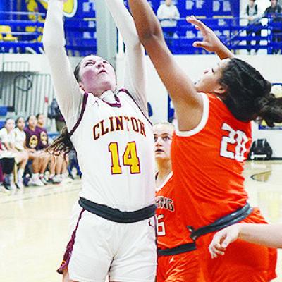 Clinton’s Brooklyn Aston attempts a layup against a Cushing defender in the Lady Reds’ playoff game against the Lady Tigers. CDN | Sam Goodwyn