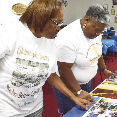 Bonnie Fisher Randle, left, and Susanna Williams go over the posters for the Excelsior School reunion parade set to start at 9 a.m. Aug. 2. CDN | Courtesy photo