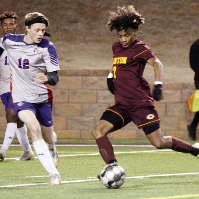 Clinton’s No. 7 Deontre Beavers prepares to send the ball past a Christian Heritage defender Monday at the Tornado Bowl. CDN | Emily Stephens CHS soccer splits pair with Knights
