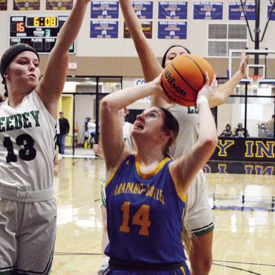 Arapaho-Butler’s Hailey Kauk shoots past two Leedey defenders. CDN | Staff photo Taking aim