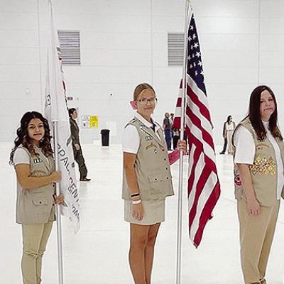 From left, Troop 262 Girl Scouts Lily Martinez, Preslie Hines, Melanie Moy, Kendra Jones, Emorie Hines, Paislee Hines, and Camila Murphy in color guard at the grand opening of the Premium Aerospace Hanger 234 in Burns Flat. CDN | Courtesy photo