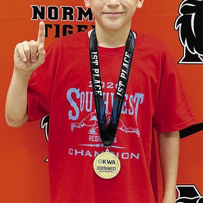 Mason Hileman smiles with his gold medal after placing first in the Southwest Regional Tournament that was held in Norman. He will wrestle at the OKWA State Tournament starting Friday in Oklahoma City. CDN |Courtesy Photo