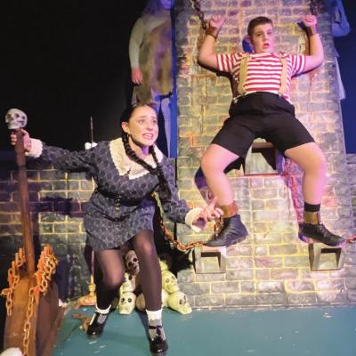 Miranda McClean, left, and Wesley Washburn star as Wednesday and Pugsley Addams in “The Addams family Musical.” Wednesday enjoys electrocuting her brother as she works through her emotions. CDN | Kelcie Hartley-Wolfe ‘Addams Family’ production by playhouse is to ‘die’ for