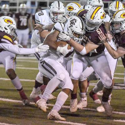 CDN | Adam Ewing Tason Turney, Cooper Sulley and Aaron Seabolt bring down an Elk City ball carrier for a loss during Clinton’s 17-7 semifinals victory. Reds return to title game