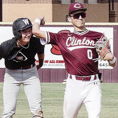 Clinton’s Declan Brown, right, throws the ball back to the pitcher after trying to keep the Weatherford runner at second during the Reds’ summer game against the Eagles. CDN | Sam Goodwyn