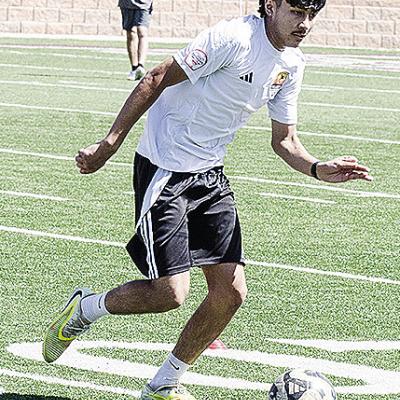Recent Clinton graduate Antonio Soto runs with the ball during a practice this spring in the Tornado Bowl. CDN | Sam Goodwyn