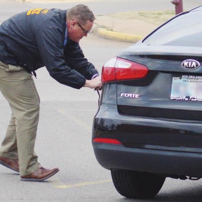 Friday morning Oklahoma City Police Inspector Doug Parker investigates a Kia Forte parked near 12th Street and Frisco. Four arrests were made of suspects in a possible homicide committed in Oklahoma City. CDN | Collin Wieder Arrests made here in OKC homicide