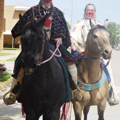 Katie Parker, left, and Cris Hart with face paint ride horses at Friday’s Cinco de Mayo parade. CDN | Michael Maresh