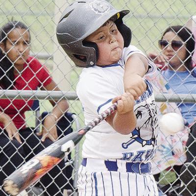 Damian Puentes of the Altus Diamond Dawgs swings mightily at the ball during the first game of the OK Kids 8U Baseball State Tournament Thursday at Schumacher Fields at Acme Brick Park. CDN | Sam Goodwyn