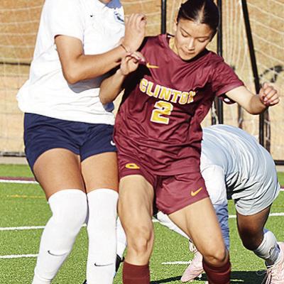 Clinton’s No. 2 Sammy Meraz battles with a Lady Patriot for control of the ball midway through the Lady Reds’ win over the Lady Patriots. CDN | Sam Goodwyn