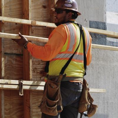 Victor Gonzalez locks in panels of wood to create the shape of the future Interstate 40 support beams at Red Wheat Drive. CDN | Christian Jacobsen