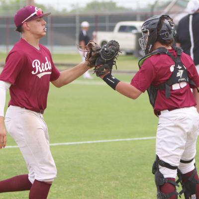 Clinton catcher Tate Wilhelm welcomes Caden Powell back to the dugout after the Reds ended the top of the fourth inning versus Pauls Valley. CDN |Adam Ewing Reds rout Pauls Valley