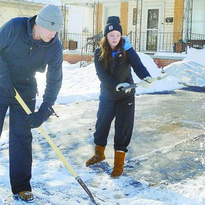 Dawson Brooks, left, and Kelcie Beals shovel the snow out from a driveway to a home Monday afternoon near downtown Clinton. CDN | Micah Ashcraft Dawson Brooks, left, and Kelcie Beals shovel the snow out from a driveway to a home Monday afternoon near downtown Clinton. CDN | Micah Ashcraft