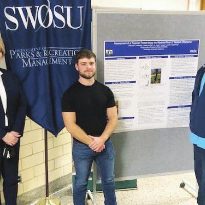 SWOSU graduate Greyson Weedon, also a Clinton High School graduate, recently presented research on Washita River riparian forests on the Weatherford campus. With him are, left, SWOSU President Dr. Diana Lovell and Dr. Zach Jones, associate professor in th Weedon part of recent