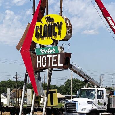 Crews worked Monday to remove the Glancy sign on Gary Boulevard. The sign will be refurbished and placed at the Oklahoma Rt. 66 Museum once the Oklahoma Highway Patrol Headquarters is torn down. CDN | Staff Photo Crews worked Monday to remove the Glancy sign on Gary Boulevard. The sign will be refurbished and placed at the Oklahoma Rt. 66 Museum once the Oklahoma Highway Patrol Headquarters is torn down. CDN | Staff Photo