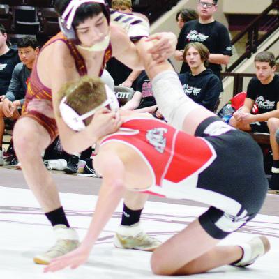 Clinton senior Alberto Rodriguez takes his Cache opponent down to the mat during the recent district duals. CDN | Staff photo Senior happy to help lead underclassmen