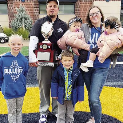 Soon to be newly-appointed Clinton football coach Trevor Powers, center, smiles with his family after finishing as runner-up in the Class A State Championship game at UCO. Pictured, from left, are daughter Tenley, Powers, son Jet, wife Shayla and twin dau