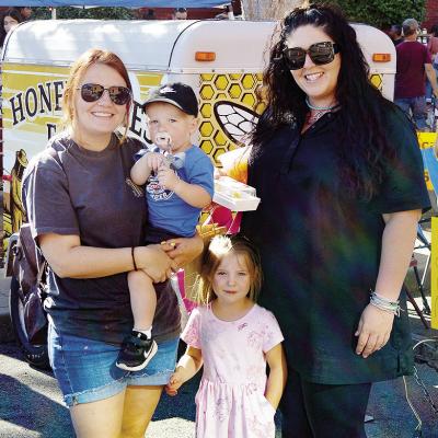 Leksi Richert, left, with her children Luke and Riley Richert, and Shakira Thigpen all enjoy the good weather and the Clinton Farmers Market Thursday at Engleman Park. CDN | Christian Jacobsen