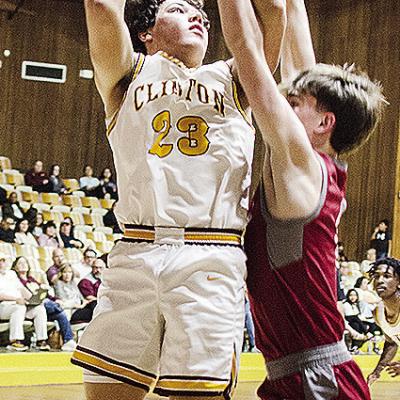 No. 23 Easten Powell jumps for the contested layup during Clinton’s regular season finale against Weatherford. CDN | Sam Goodwyn