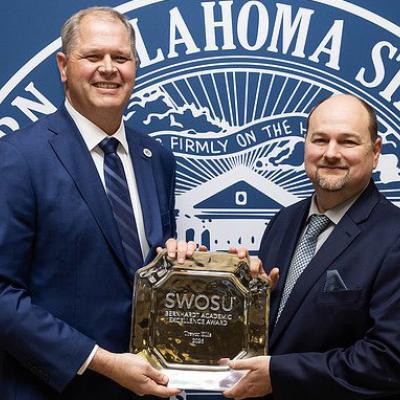 Interim President Dr. Joel Kendall, left, presents the 2026 Bernhardt Academic Excellence Award to Dr. Trevor Ellis at Southwestern Oklahoma State University. CDN | Courtesy photo