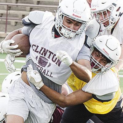 Clinton’s Jesus Gutierrez, left, runs through CJ Begay’s tackle during Monday’s football practice at the Tornado Bowl. CDN | Sam Goodwyn