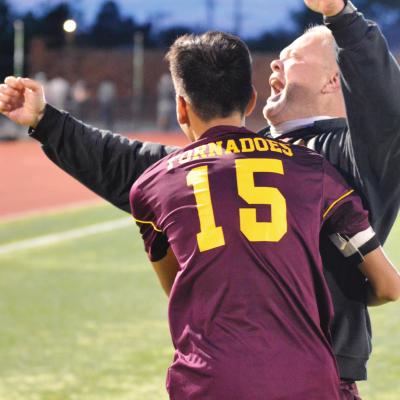 Clinton boys’ soccer coach Gene Ray celebrates after the Reds won the state title, as upcoming senior defender Adan Flores sprints in to hug him. Both were named to the All-District team. CDN | Collin Wieder Awards still pour in for state champs