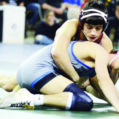 Clinton 113-pounder Alberto Rodriguez, top, controls Harrah’s Liam Russell after an early takedown. CDN | Staff photo Bennett places third at state