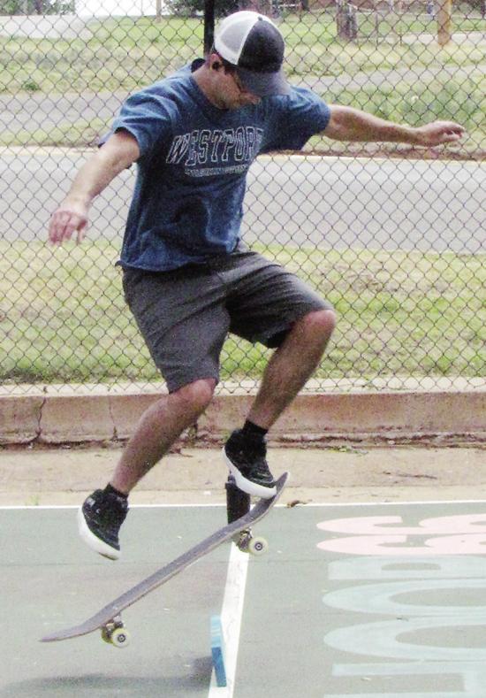 Kaelib Simpson practices his “ollie” skateboard trick Tuesday at McLain Rogers Park in the basketball court. CDN | Christian Jacobsen