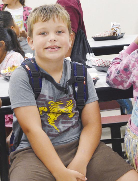 Grayson Wagoner waits for lunch to be over for the outdoor activities at Washington Elementary during Summer Playground. CDN | Christian Jacobsen