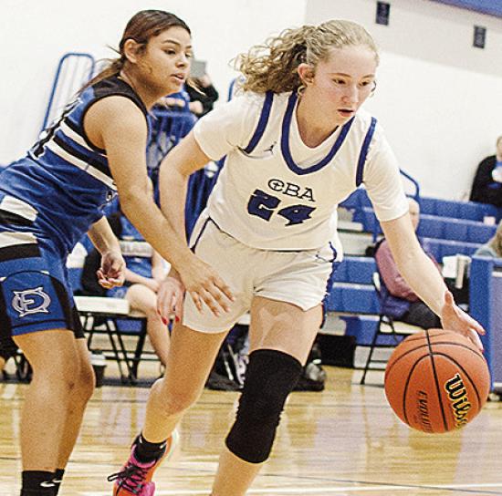 Lady Crusaders’ Brylie Driskill controls the ball against the defender as she drives to the basket in CBA’s win over O-E CDN | Sam Goodwyn