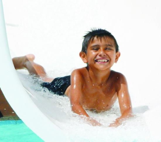 Abel Ponce slides down face first on the water slide at the Clinton Public Pool.