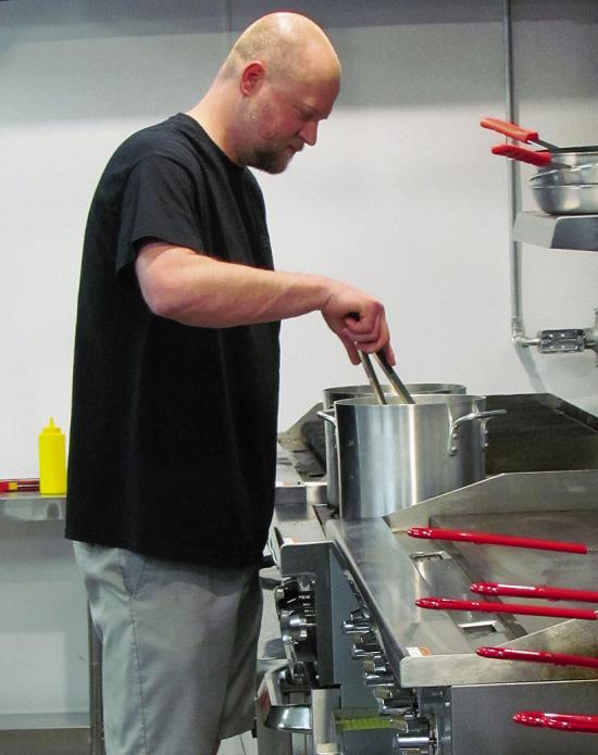 Clint Lively preps food for the coming patrons on the opening night at The B.A.C.K. Room restaurant.