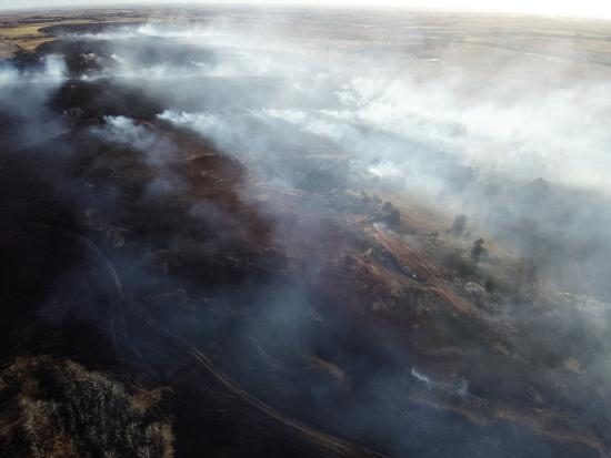 A drone image shows the extent of smoldering damage wrought to the countryside from the fire near the 75 mile marker on Interstate 40. CDN | Courtesy photo