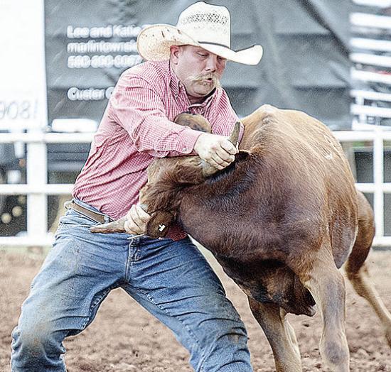Hunter Washburn wrestles the steer during the rodeo Saturday at the Clinton Round-Up Club Arena. CDN | Sam Goodwyn Hunter Washburn wrestles the steer during the rodeo Saturday at the Clinton Round-Up Club Arena. CDN | Sam Goodwyn