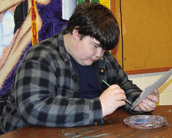 Colton Ackerman adds additional color to his abstract art piece Thursday at Clinton High School. CDN | Christian Jacobsen