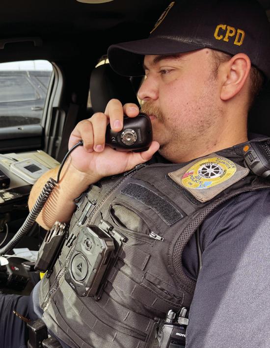 Officer Tucker Stevens takes a call in his patrol vehicle. CDN | Shiann Dawson