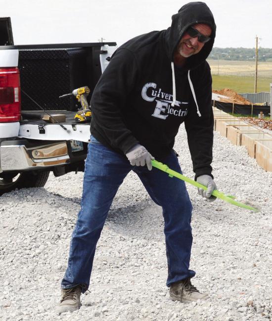 Subcontractor Jeremy Fisher spreads out rock and gravel using Bryler Daggs’ shovel recently at the Clinton Regional Airport. Daggs, his grandson, placed the shovel into his work truck and told him, “I’ll let you use my shovel at work.” CDN | Chris