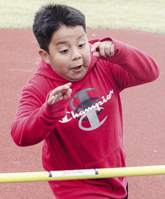 Alex Perez Delacruz focuses on the bar as he attempts to jump over it Tuesday during the Little Olympics at the high school. CDN |Sam Goodwyn