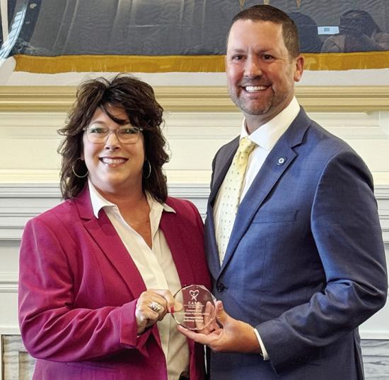 Jackie Aaron, left, executive director of CASA of Western Oklahoma, presents the Champions of Children Award to Rep. Anthony Moore. CDN | Courtesy photo