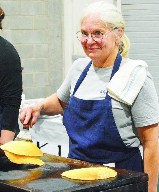 Jill Weedon flips a fresh stack of flapjacks during the annual Kiwanis Club Pancake Day Thursday evening at the Frisco Center. CDN | Micah Ashcraft